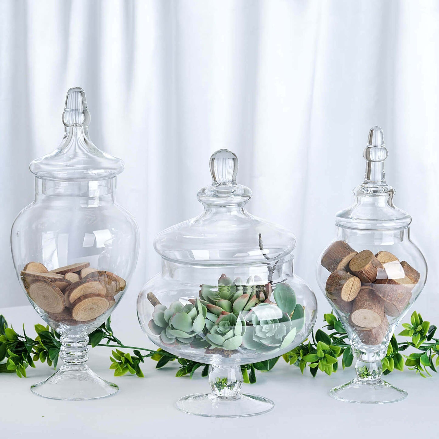 Set of 3 Glass Candy Jars Pedestal Apothecary Design Clear with Snap - On Lids - Stylish Party Favor Containers 10"/12"/14" - Linen Luxes