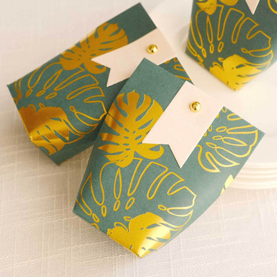 25 Pack Hunter Emerald Green Paper Pouch Candy Gift Bags With Gold Monstera Leaves Print, Party Favor Boxes with Pin and Tags - 4.5"x4"